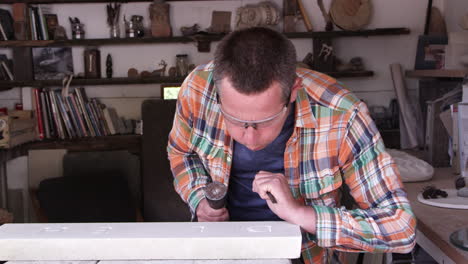 Stone Mason At Work On Carving In Studio Shot On RED Camera
