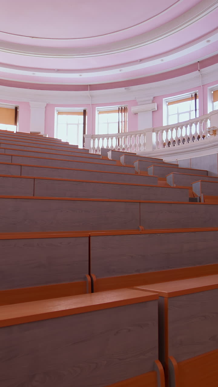 Lecture hall with nobody. Modern educational auditorium in the university. Interior of a large empty classroom during coronavirus pandemic. Vertical video