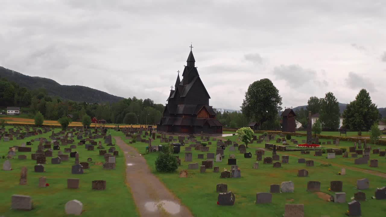 Church located in Norway, surrounded by a graveyard and peaceful natural landscape
