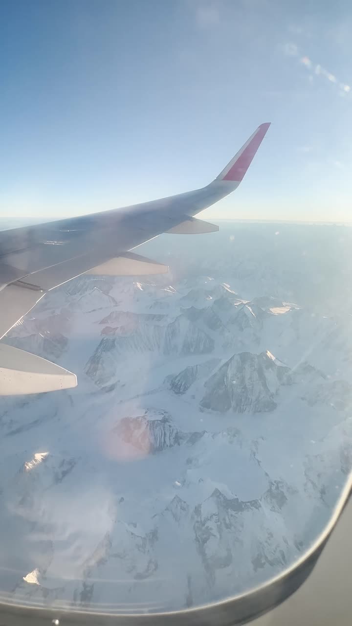 Himalayas view of the window of airplane wing from airplane