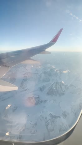 himalayas view of the window of airplane wing from airplane
