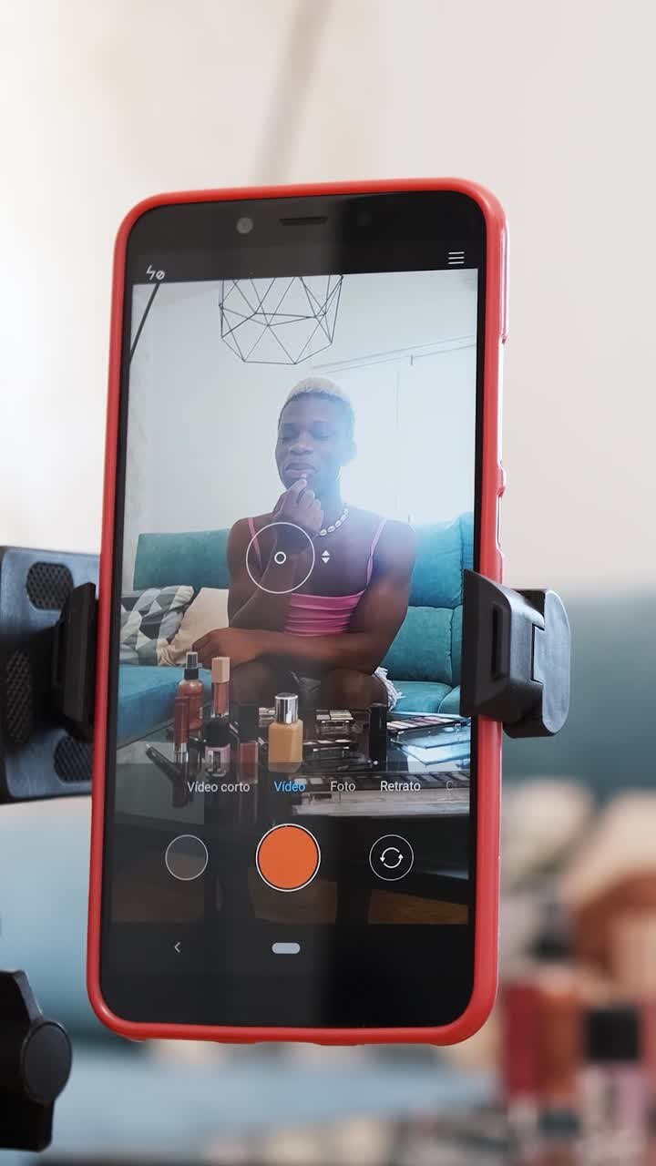 Uomo che registra un video tutorial di trucco su uno smartphone