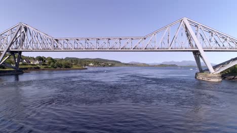 right to left aerial shot tracking the connel bridge on a clear day looking towards mull