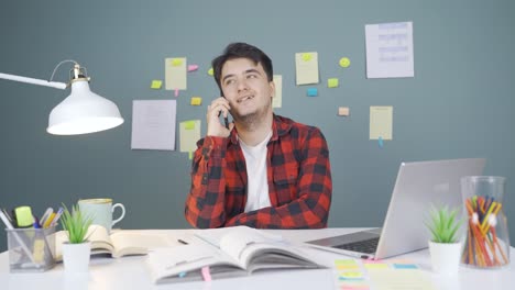 male student chatting with his girlfriend on the phone.