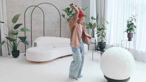 young joyful african american woman performs energetic dance in living room