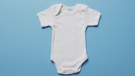 Video-of-whit-baby-grow-with-copy-space-on-blue-background