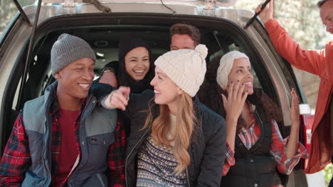 Friends-sit-talking-at-the-open-back-of-a-car,-close-up