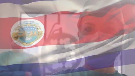 Animación-De-La-Bandera-De-Costa-Rica-Ondeando-Sobre-Cirujanos-En-Quirófano