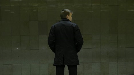 person standing in an underground station