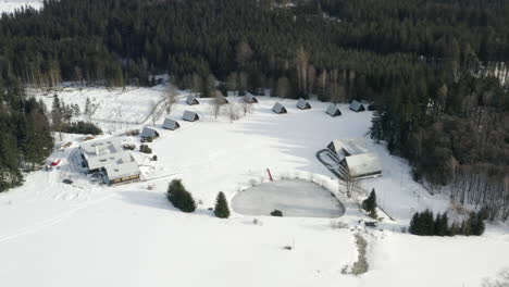 toma aérea del campamento de esquí de invierno en un paisaje montañoso alpino durante el invierno, cubierto de nieve