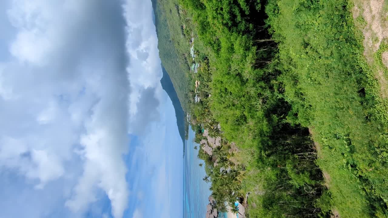 Vertical scenic pan of Sofitel Hotel with overwater villa bungalows and crystal clear turquoise ocean water on tropical Moorea Island in French Polynesia, South Pacific