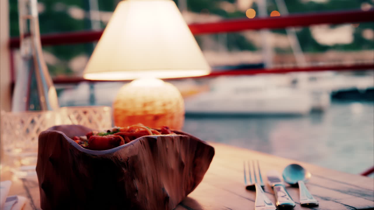 Close up view of a lamp on a set table at a restaurant near a port in the south of France