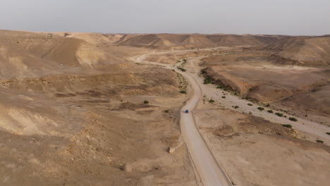 on the road to salalah, oman, the vast, dry desert stretches out with winding paths