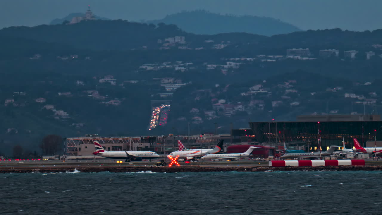 Nice, France - January 10, 2025: Airplane moving at the Nice Cote d'Azur Airport in the evening with the mountains on the background