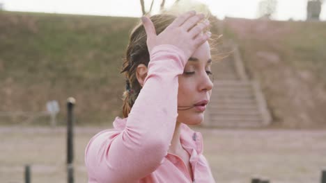 caucasian woman tired after exercising at bootcamp