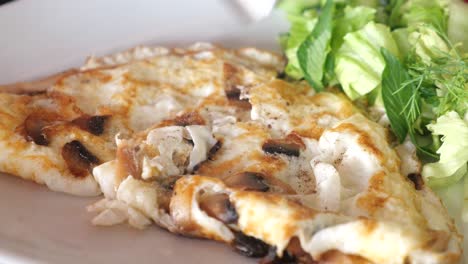 a delicious omelette with mushrooms and salad