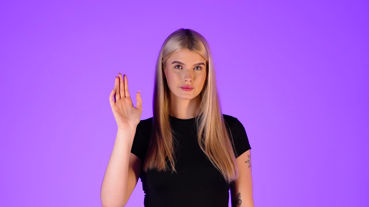 Attractive Blonde Woman Waving Hand, Greeting Gesture, Colorful Studio Portrait