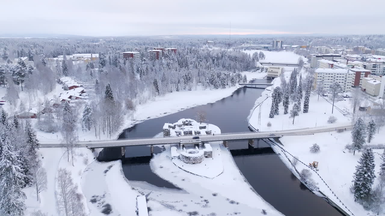 Drone tilting over the Kajaani castle, cloudy, winter day in Kainuu, Finland