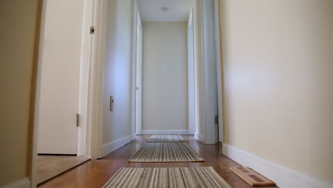 camera glides down home hallway