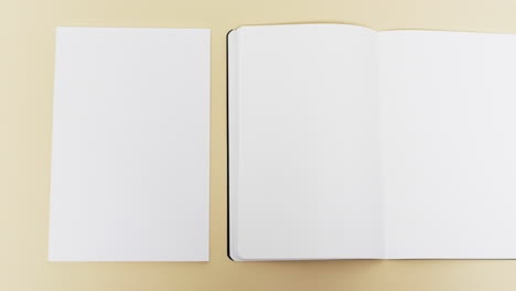 video of books with white blank pages and copy space on yellow background