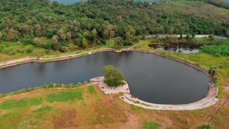 uhd drone shot birds-eye view picnic spot by the lake over the mountain jungle