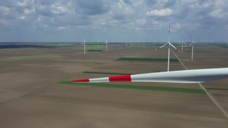 aerial view of several windmills, wind generators, turbines, producing renewable clean energy by converting kinetic energy