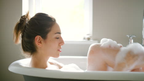 woman relaxing in a bubbly bath