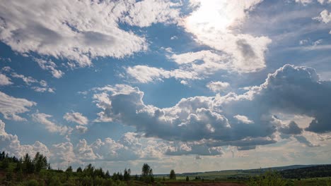 white clouds, clear soft sky, time lapse formating cloudscape in horizon, rainy rolling fast moving, beautiful summer sunny day, colourful weather.