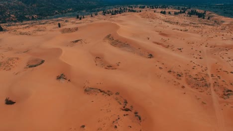 drone forward tilt up over orange desert sand dunes in utah, usa, mars look