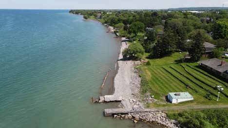 drone flying away from lake ontario coastline in grimsby on a sunny summer day