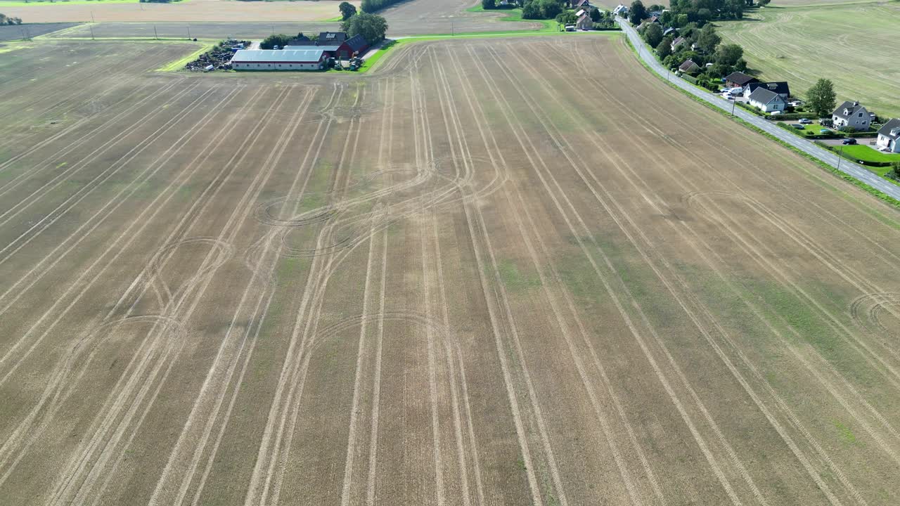 Drone areial of rural fields and houses in H&auml;sslunda near M&ouml;rarp in Sk&aring;ne, Sweden