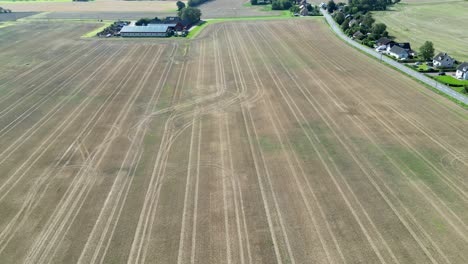 Drone-areial-of-rural-fields-and-houses-in-Hässlunda-near-Mörarp-in-Skåne,-Sweden