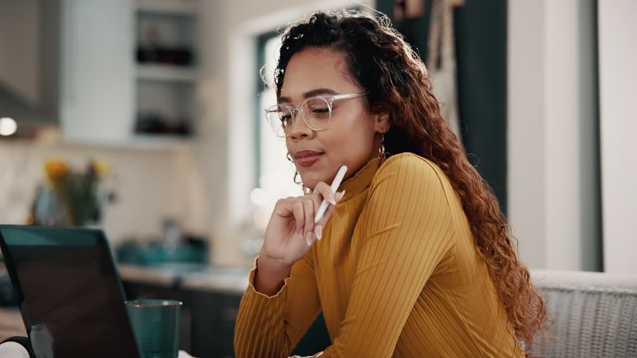 A woman works on her laptop at home