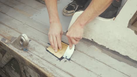 sealing wooden cap on starboard side of wooden boat deck planking flattening mastic sika flex