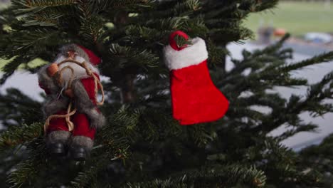 hanging red christmas stocking on green christmas tree 4k