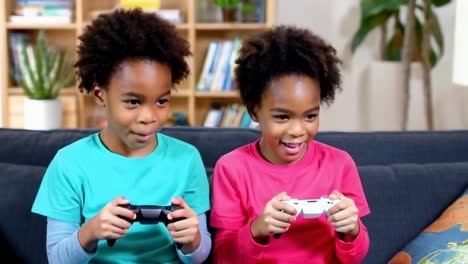 two young children are playing a video game together on a couch