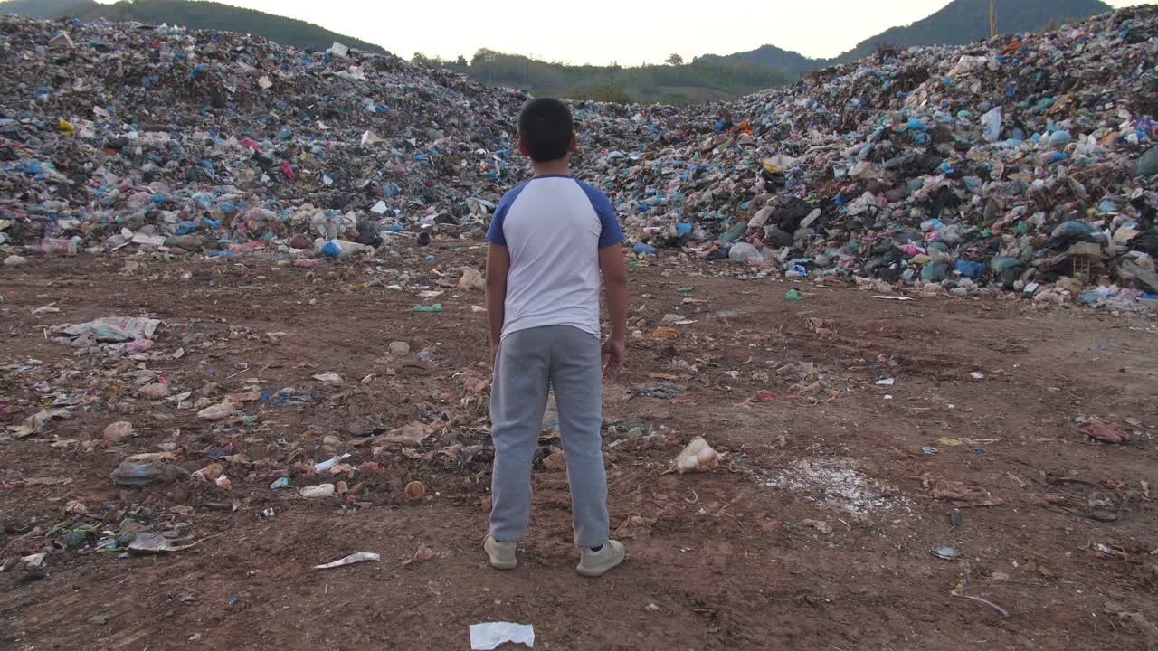 A Child Stands in a Landfill