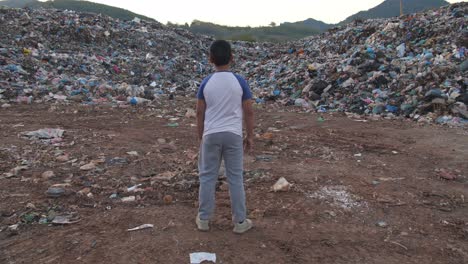 a child stands in a landfill