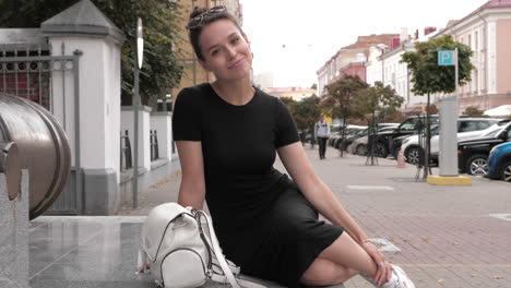 woman sitting on city street