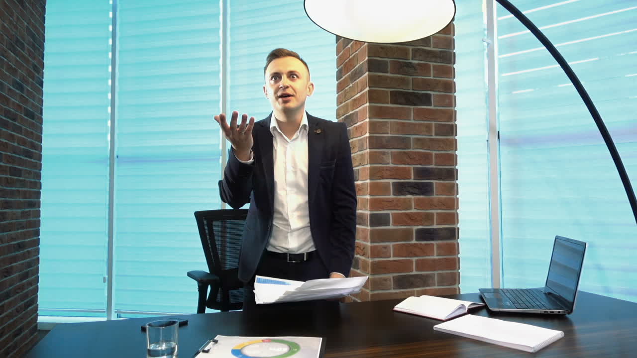 Young Businessman Screaming At Someone. Young angry businessman screaming at someone and throwing paper sheets