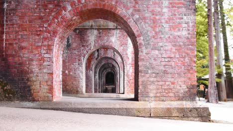 slide shot looking through under the brick bridge in kyoto, japan 4k slow motion right to left