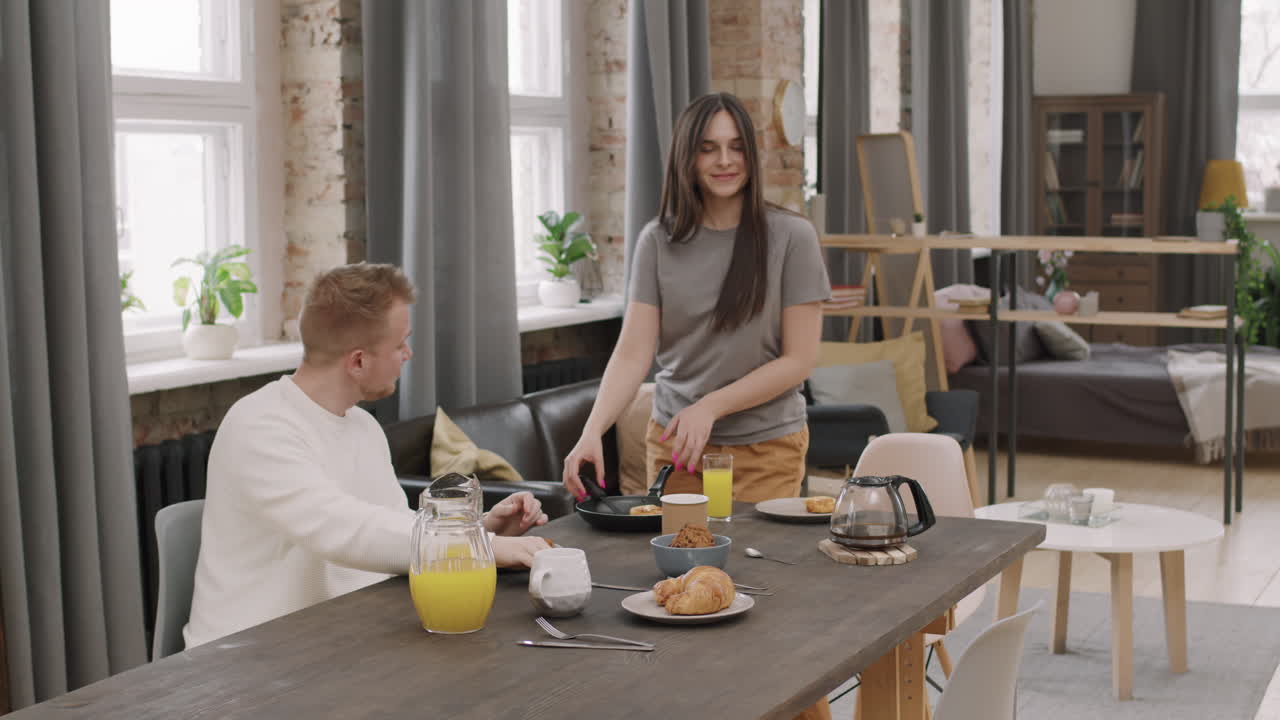 Happy Woman Dancing and Serving Pancakes for Breakfast