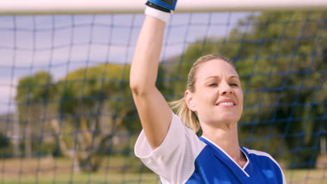 Goalkeeper-in-blue-making-gesture-