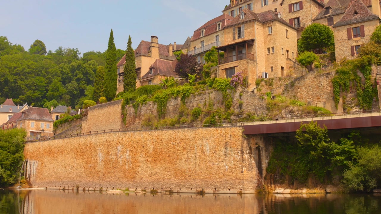 Close view of medieval stone houses built on the cliffside in Beynac, France, part of one of the most beautiful villages.