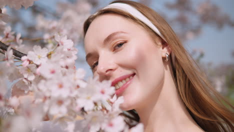 happy girl with sakura flowers smiling at camera - yangjae citizens forest in seocho, seoul, south korea