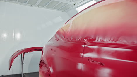 red car in paint booth