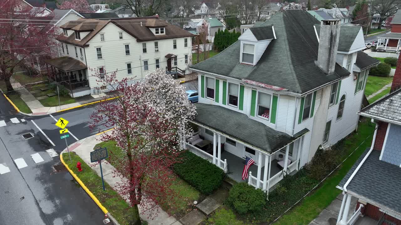 Proud Population in american town with single family house and hoisted up flag of USA