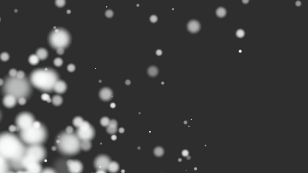 Small white particles and round bokeh on black background