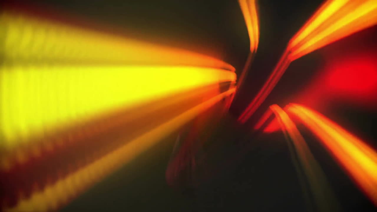 Radiating yellow and red light beams in animation over dark background