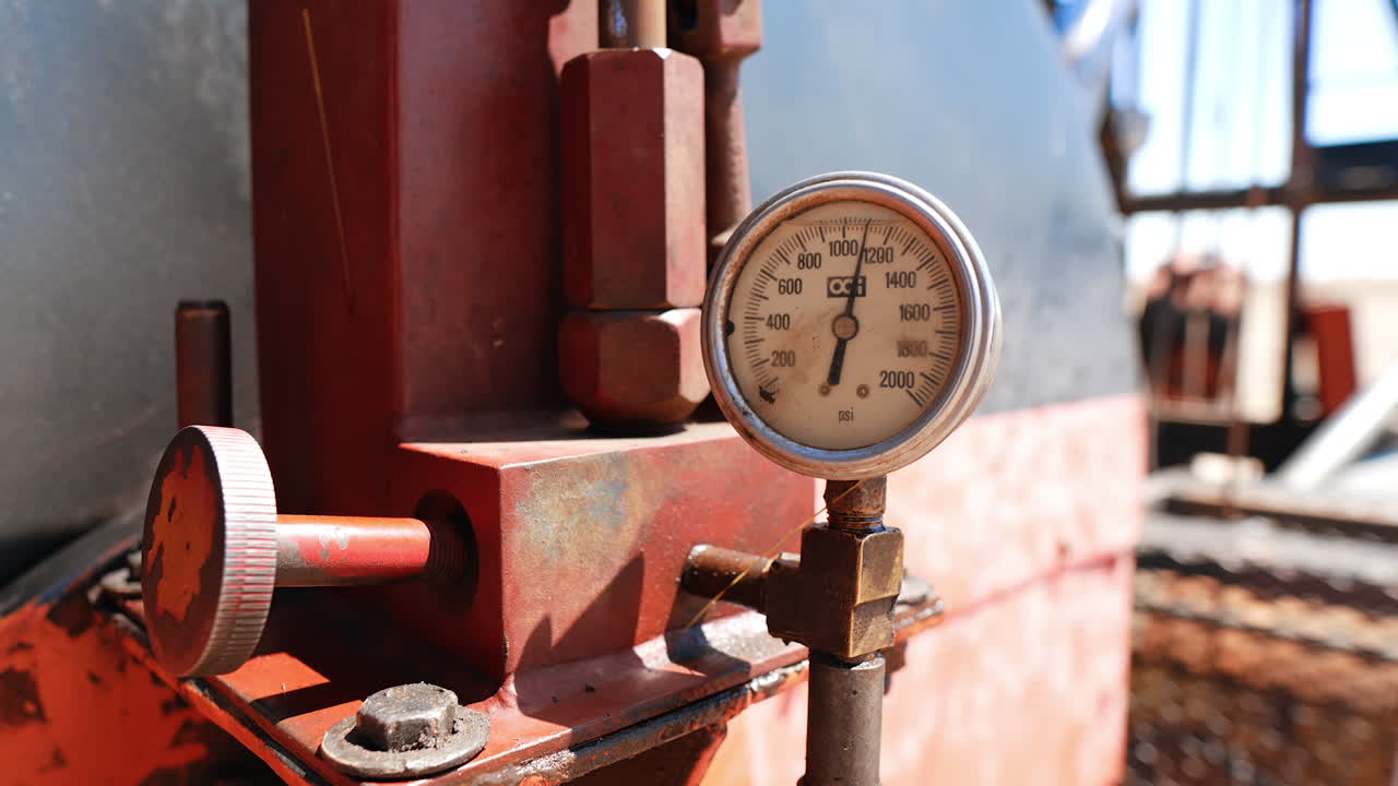 Metal details with a monometer attached. Close up. Oil or gas industry production.